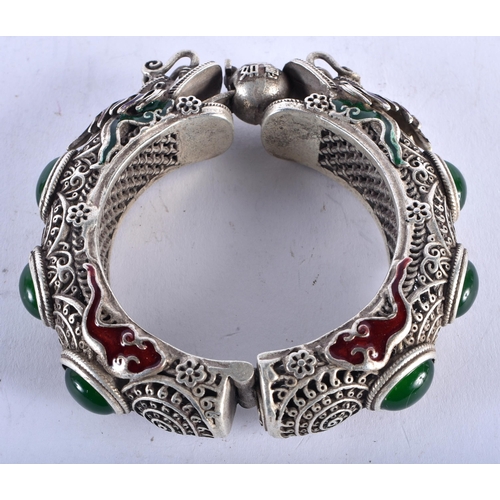 1329 - A CHINESE WHITE METAL AND ENAMEL BANGLE. 136 grams. 6 cm wide.