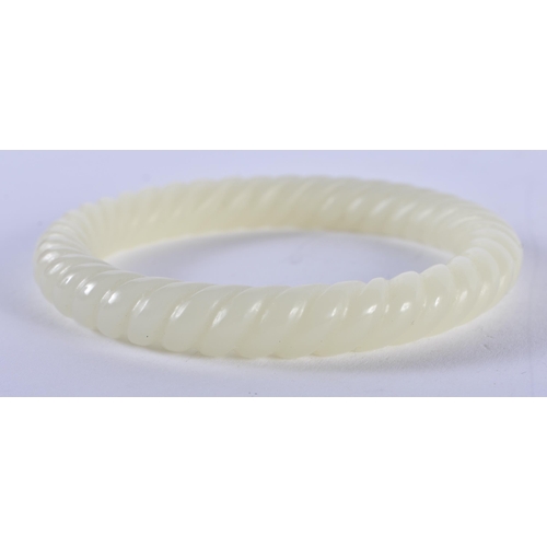 1363 - A CHINESE CARVED JADE TWIST BANGLE. 41 grams. Internal width 6 cm.