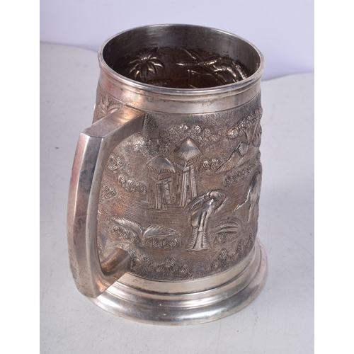 1444 - A Large Indian Sterling Silver heavily embossed Tankard. Stamped Sterling. 12cm x 14cm x 11cm. Weigh... 