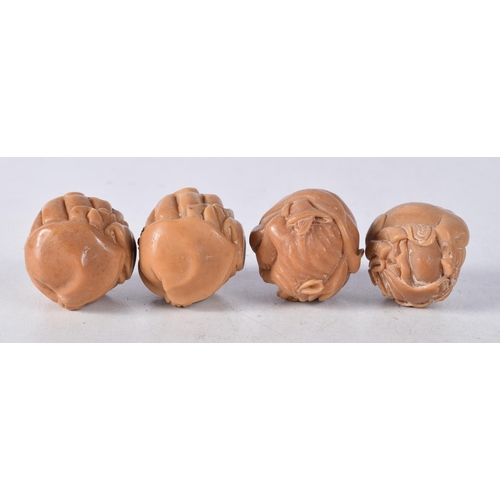 1448 - Four Nuts Carved with Figures. 3.3cm x 2.8cm x 2.7cm, total weight 58g (4)