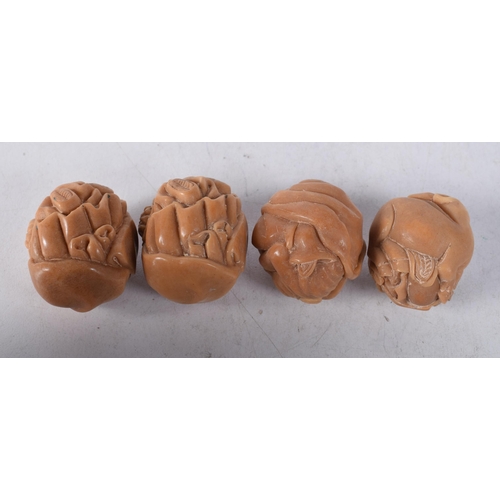 1448 - Four Nuts Carved with Figures. 3.3cm x 2.8cm x 2.7cm, total weight 58g (4)