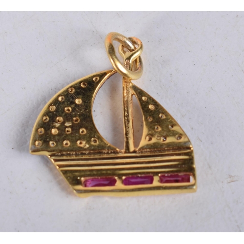 1489 - A DIAMOND AND RUBY GOLD CHARM. 1.3 grams. 2 cm x 1.5 cm.