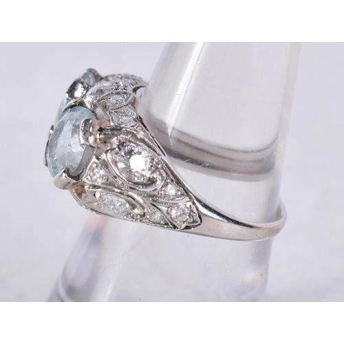 1497 - AN ART DECO PLATINUM DIAMOND AND DOUBLE AQUAMARINE RING. M. 6.3 grams.