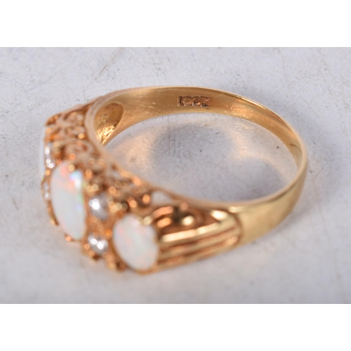 1531 - A 18 Carat Gold Ring Set with 3 Opals and 4 Diamonds. Stamped 18CT, Size P, weight 3.2g.