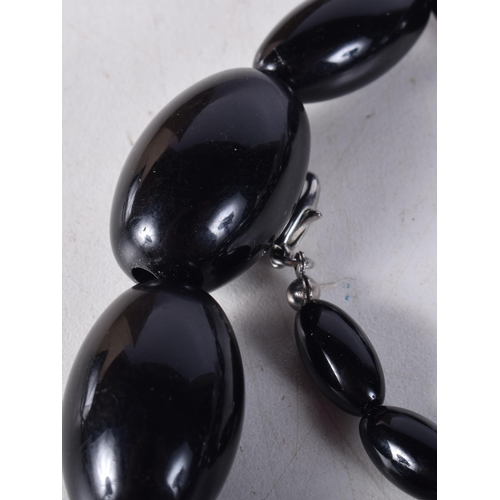 1608 - A LARGE DARK CHERRY AMBER NECKLACE. 93 grams. 68 cm long, largest bead 3.75 cm x 2 cm.