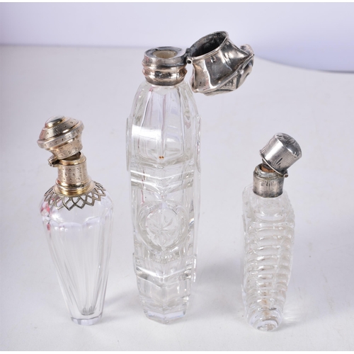 1706 - THREE ANTIQUE SILVER SCENT BOTTLES. 187 grams overall. Largest 12 cm high. (3)