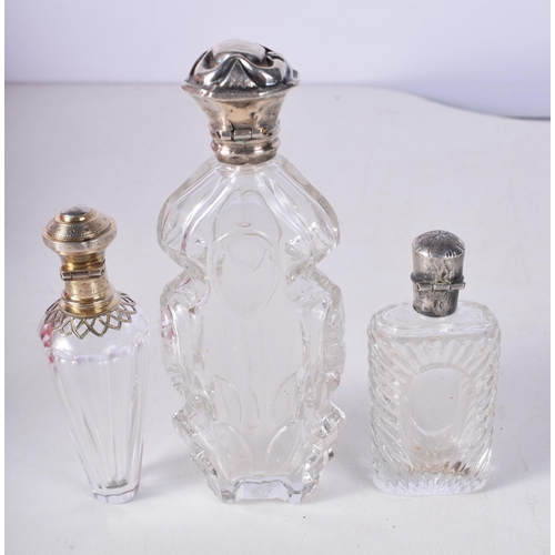 1706 - THREE ANTIQUE SILVER SCENT BOTTLES. 187 grams overall. Largest 12 cm high. (3)