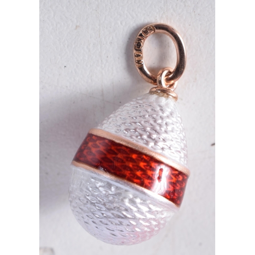 1733 - A 14 Carat Gold and Red Enamel Egg Pendant. Stamped 56, 2.1cm x 1.3cm, weight 2.5g