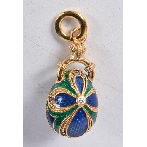 1741 - A Continental Silver Gilt and Enamel Egg Pendant. Stamped 84. 2.6cm x 1.2cm, weight 6.6g