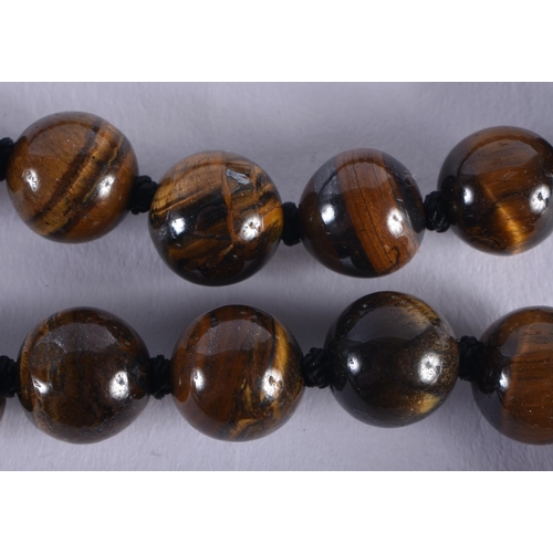 2689 - A CHINESE TIGERS EYE NECKLACE 20th Century. 84 grams. 92 cm long.