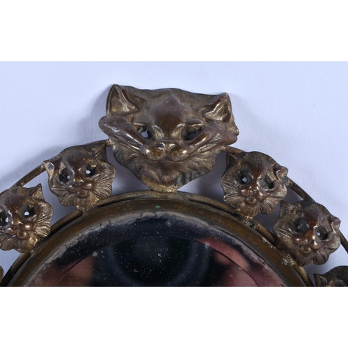 524 - A VERY UNUSUAL LATE VICTORIAN/EDWARDIAN CAT HEAD FELINE MIRROR with bamboo shaft. 36 cm long.