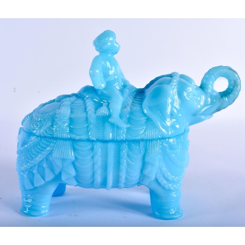 765 - A RARE VALLERYSTHAL PRESSED BLUE GLASS BOX AND COVER formed as a seated male upon an elephant. 18 cm... 