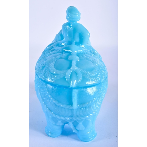 765 - A RARE VALLERYSTHAL PRESSED BLUE GLASS BOX AND COVER formed as a seated male upon an elephant. 18 cm... 