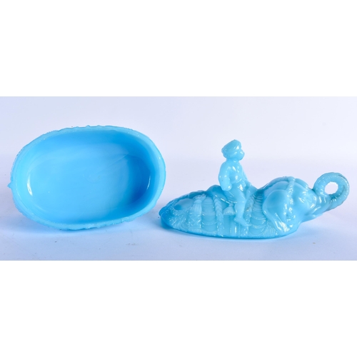 765 - A RARE VALLERYSTHAL PRESSED BLUE GLASS BOX AND COVER formed as a seated male upon an elephant. 18 cm... 