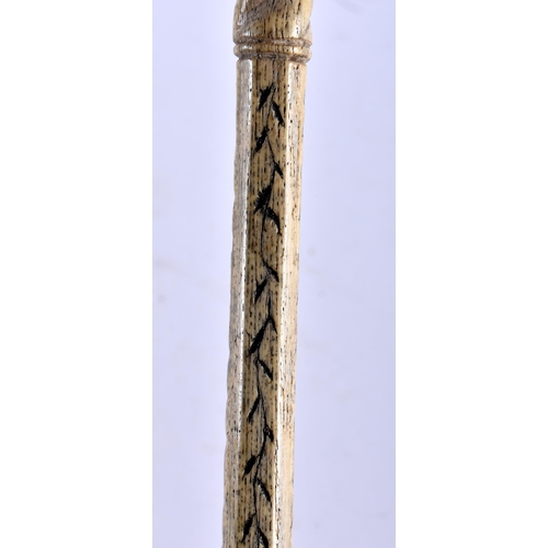 768 - AN 18TH CENTURY CARVED SCRIMSHAW SAILORS WHALE BONE WALKING CANE. 87 cm long.