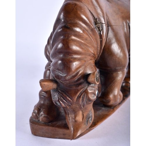 771 - A RARE 19TH CENTURY CHINESE CARVED HARDWOOD FIGURE OF A RHINOCEROS modelled upon a shaped base. 27 c... 