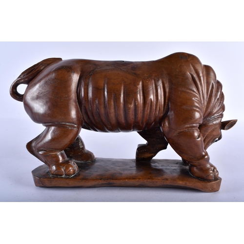 771 - A RARE 19TH CENTURY CHINESE CARVED HARDWOOD FIGURE OF A RHINOCEROS modelled upon a shaped base. 27 c... 