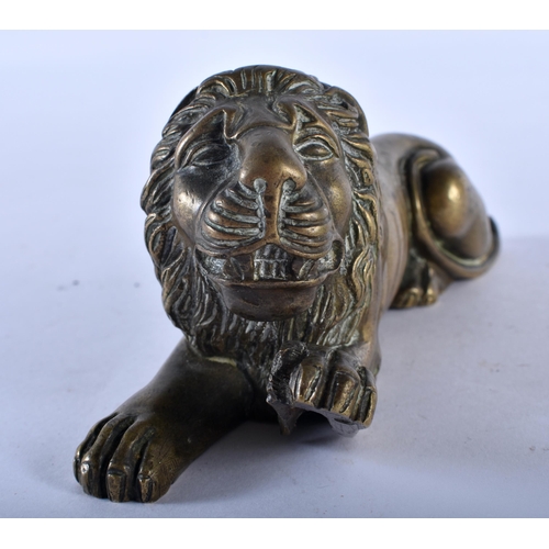 777 - A REGENCY BRONZE FIGURE OF A RECUMBANT LION. 12 cm x 6 cm.