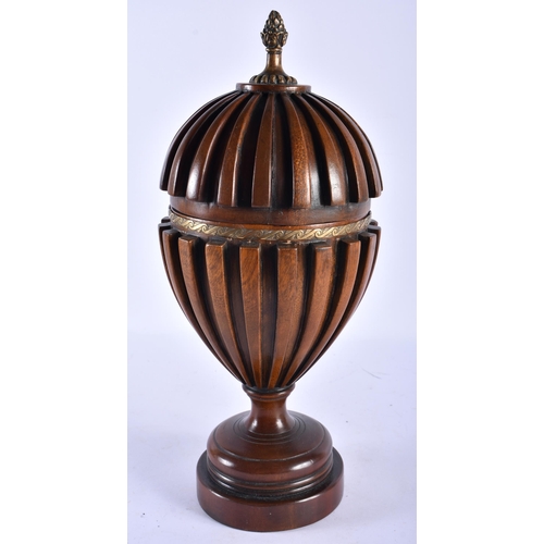 782 - AN ANTIQUE CARVED WOOD TREEN VASE AND COVER with gilt metal banding. 37 cm high.