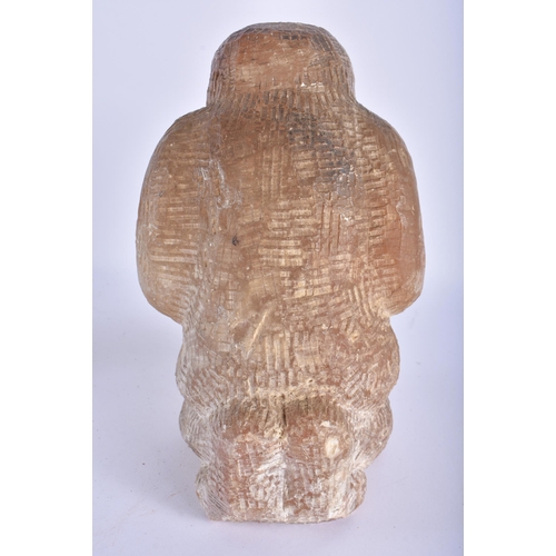 795 - AN UNUSUAL EARLY 20TH CENTURY NORTH AMERICAN INUIT CARVED STONE FIGURE modelled kneeling. 24 cm x 12... 