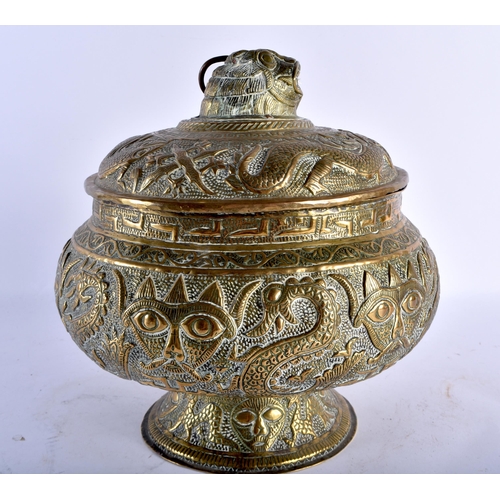 796 - A 19TH CENTURY INDIAN EMBOSSED BRASS VASE AND COVER decorated with Hindu figures and mythical beasts... 