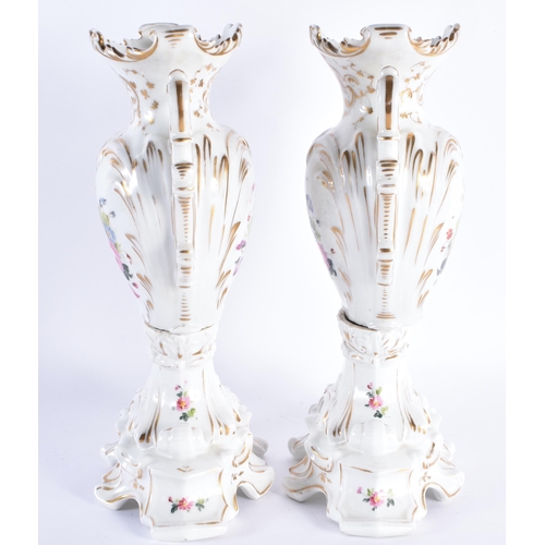 106 - A LARGE PAIR OF 19TH CENTURY PARIS PORCELAIN TWIN HANDLED VASES painted with flowers and highlighted... 