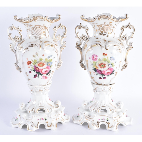 106 - A LARGE PAIR OF 19TH CENTURY PARIS PORCELAIN TWIN HANDLED VASES painted with flowers and highlighted... 