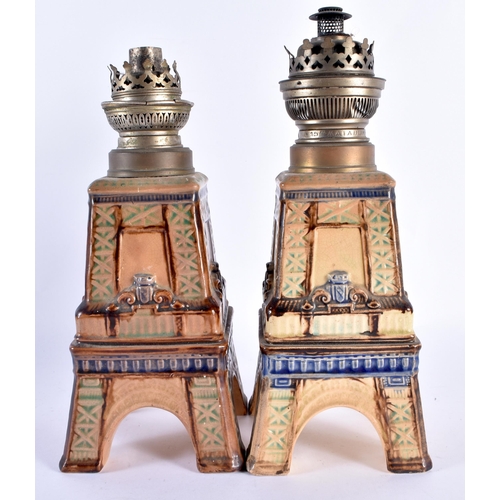 107 - A PAIR OF 19TH CENTURY POTTERY EIFFEL TOWER OIL LAMPS. 30 cm high.