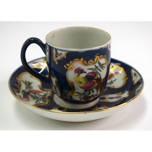 131 - 18th century Worcester cup and saucer painted with fancy birds in gilt rococo frames on a blue scale... 