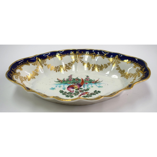 140 - 18th century scalloped oval dish painted with exotic birds in landscape surrounded by gilt pedants a... 