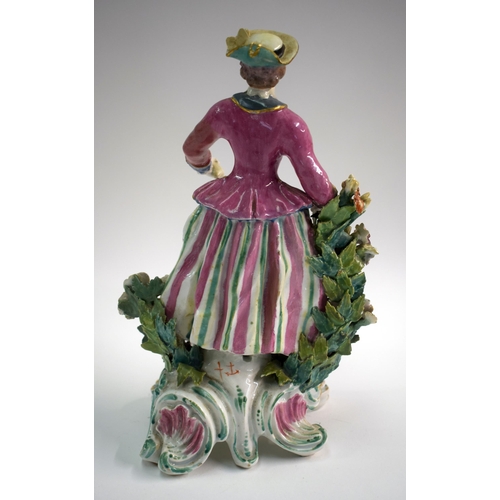 172 - 18th century Bow figure of a huntswoman holding a hare and a game bird in her right hand and a flask... 