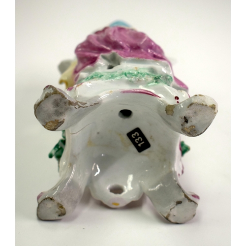 176 - 18th century Bow male figure of autumn, holding a basket of grapes, seated on a rococo base. 16cm hi... 