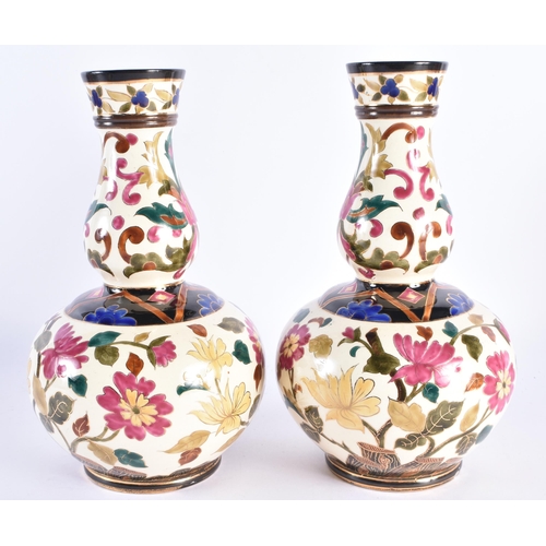 95 - A PAIR OF 19TH CENTURY CONTINENTAL POTTERY GOURD VASES in the manner of Zsolnay or Fischer, painted ... 