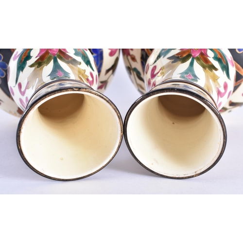 95 - A PAIR OF 19TH CENTURY CONTINENTAL POTTERY GOURD VASES in the manner of Zsolnay or Fischer, painted ... 