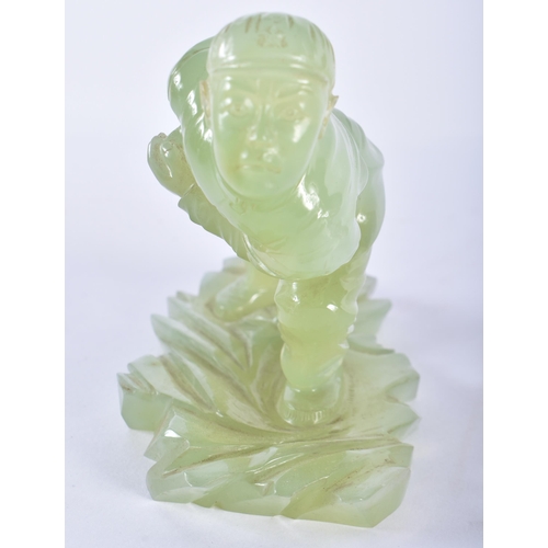 128 - A VERY RARE CHINESE CULTURAL REVOLUTION CARVED JADE FIGURE OF A SOLDIER modelled leaning forward upo... 