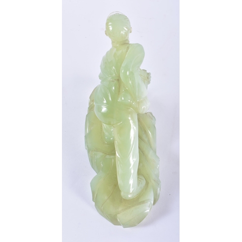 128 - A VERY RARE CHINESE CULTURAL REVOLUTION CARVED JADE FIGURE OF A SOLDIER modelled leaning forward upo... 