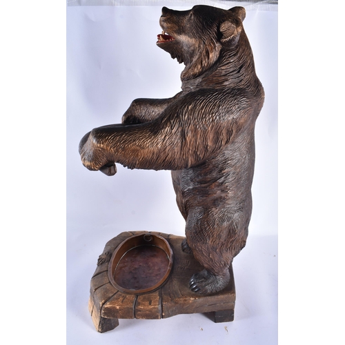 157 - A LARGE 19TH CENTURY BAVARIAN BLACK FOREST BEAR STICK STAND modelled scowling holding a bowed suppor... 