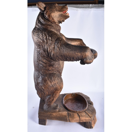 157 - A LARGE 19TH CENTURY BAVARIAN BLACK FOREST BEAR STICK STAND modelled scowling holding a bowed suppor... 