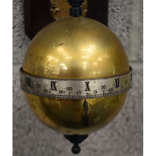 165 - A Thwaites & Reed limited edition gravity timepiece, circa 1972, the suspended brass globe with silv... 