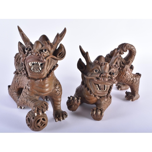 166 - A PAIR OF 19TH CENTURY CHINESE CARVED YIXING STONEWARE BUDDHISTIC LIONS Qing. 18 cm x 20 cm.