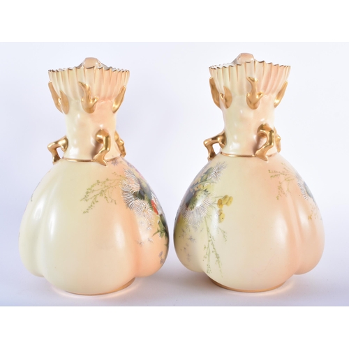 177 - A PAIR OF ROYAL WORCESTER BLUSH IVORY PORCELAIN JUGS painted with dandelions. 19 cm high.