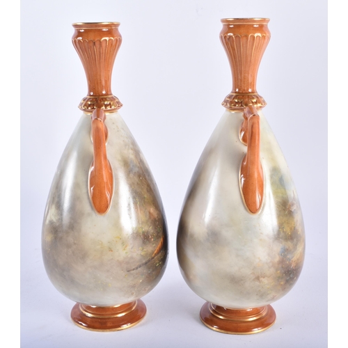 189 - A PAIR OF ROYAL WORCESTER TWIN HANDLED PORCELAIN VASES by James Stinton, painted with game birds. 21... 