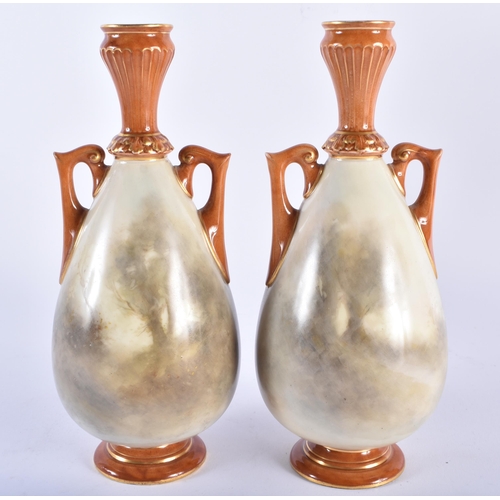 189 - A PAIR OF ROYAL WORCESTER TWIN HANDLED PORCELAIN VASES by James Stinton, painted with game birds. 21... 