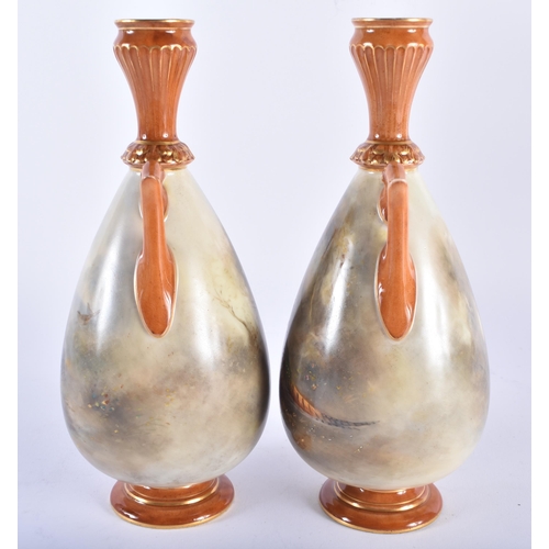 189 - A PAIR OF ROYAL WORCESTER TWIN HANDLED PORCELAIN VASES by James Stinton, painted with game birds. 21... 