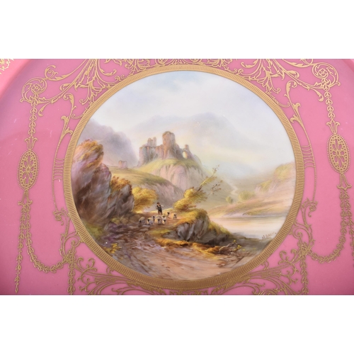 204 - A ROYAL WORCESTER PINK GROUND PORCELAIN CIRCULAR PLATE by Harry Davis. 24.5 cm diameter.