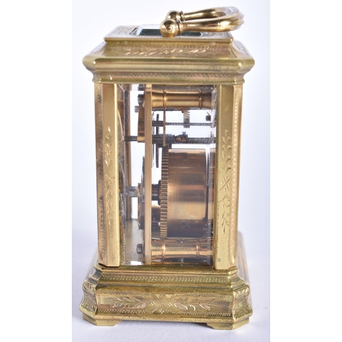 210 - A MINIATURE LATE 19TH CENTURY ENGRAVED BRASS CARRIAGE CLOCK decorated with foliage. 9 cm high inc ha... 