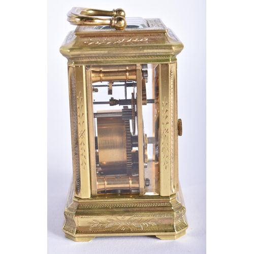 210 - A MINIATURE LATE 19TH CENTURY ENGRAVED BRASS CARRIAGE CLOCK decorated with foliage. 9 cm high inc ha... 