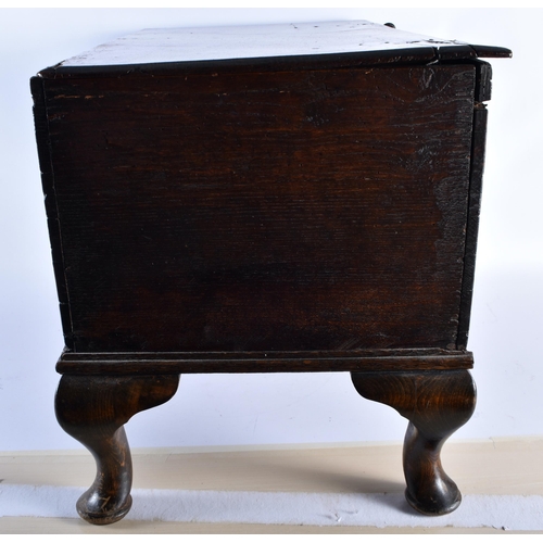 215 - A SMALL 18TH CENTURY CARVED OAK COFFER upon later feet, initialled SW & bearing date 97. 65 cm x 35 ... 