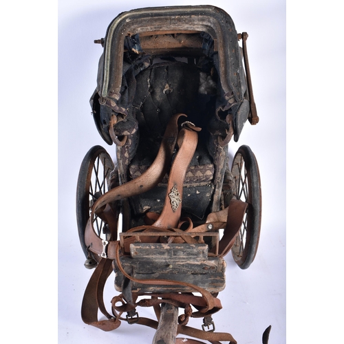 216 - A VICTORIAN LEATHER DOLLS PULL ALONG PRAM. 60 cm x 48 cm.