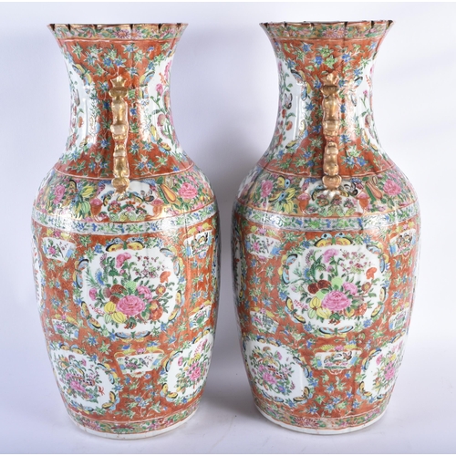 218 - A LARGE PAIR OF 19TH CENTURY CHINESE CORAL GROUND FAMILLE ROSE PORCELAIN STRAITS VASES Qing, painted... 